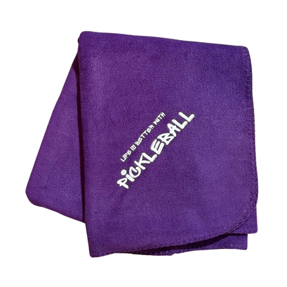 Purple fleece blanket with 'Pickleball' text in white embroidery