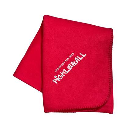 Red blanket with 'Live in Batter with Pickleball' text in white embroidery