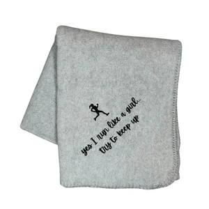gray running blanket with black embroidery of a girl runner and "yes I run like a girl...try to keep up" underneath the runner