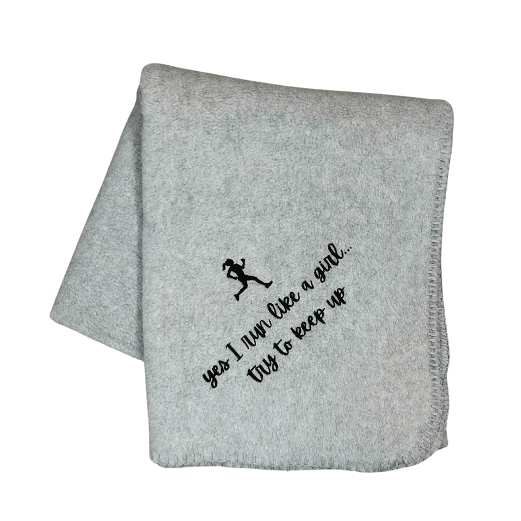 gray running blanket with black embroidery of a girl runner and 