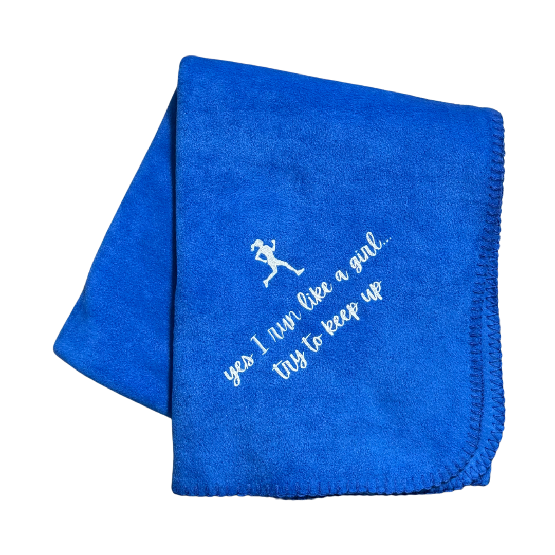 Blue blanket with white text and running girl graphic in white