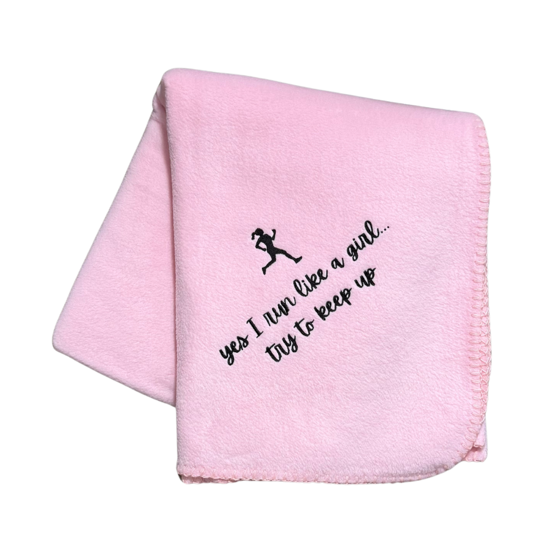 Pink blanket with black text and silhouette of a girl running