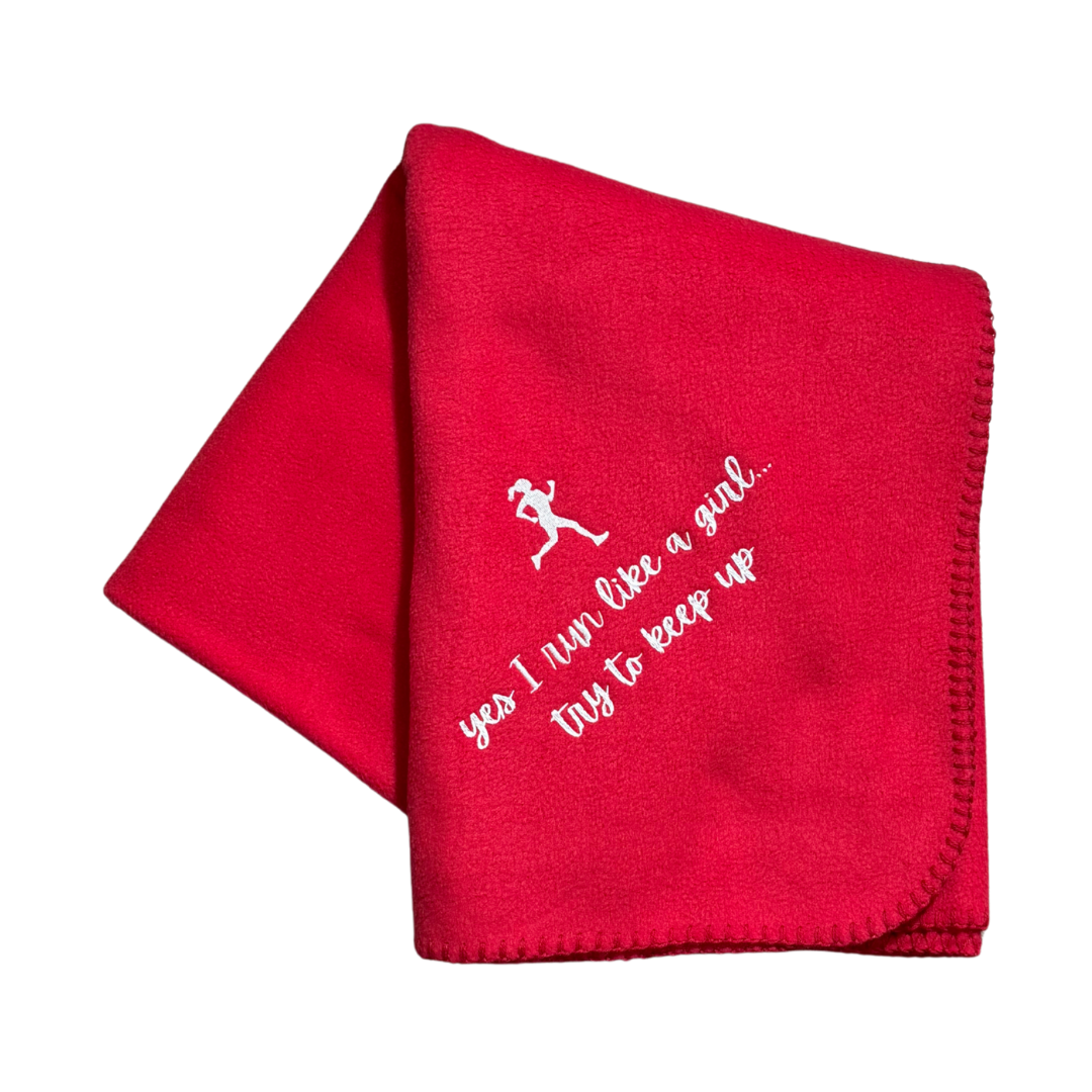 Red blanket with white text and running girl graphic