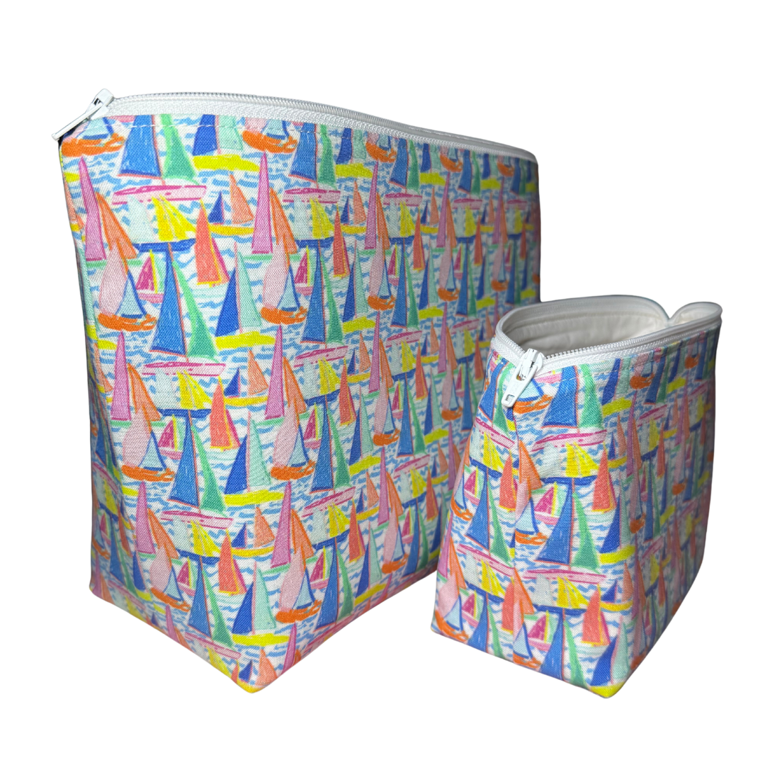 Two colorful bags with sailboat pattern on a white background