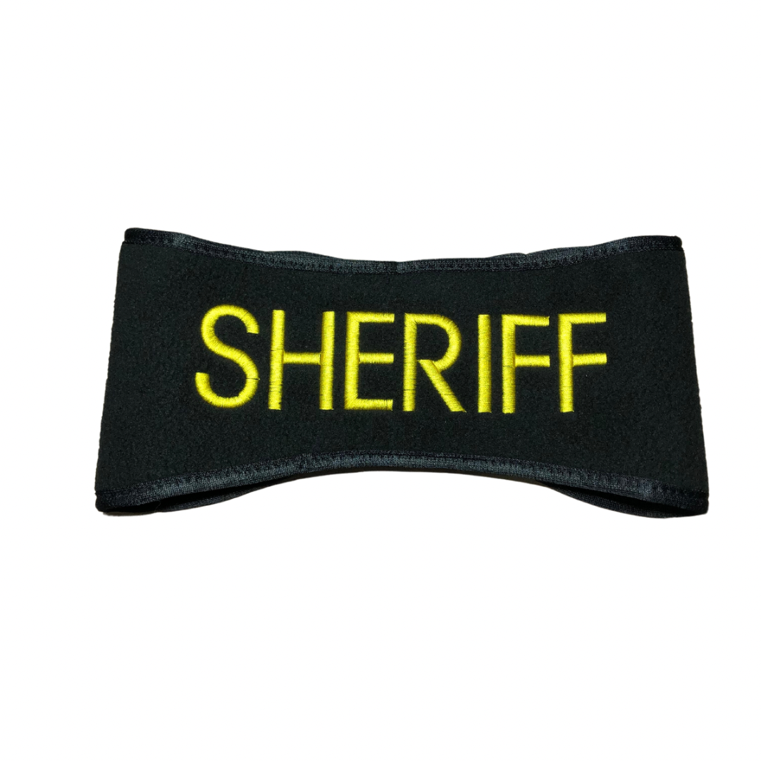 A black fleece headband with the word 'SHERIFF' embroidered in yellow.