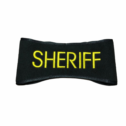 A black fleece headband with the word 'SHERIFF' embroidered in yellow.