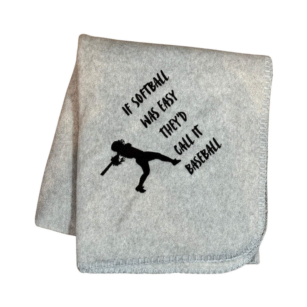 Gray blanket with black text and silhouette of a softball player