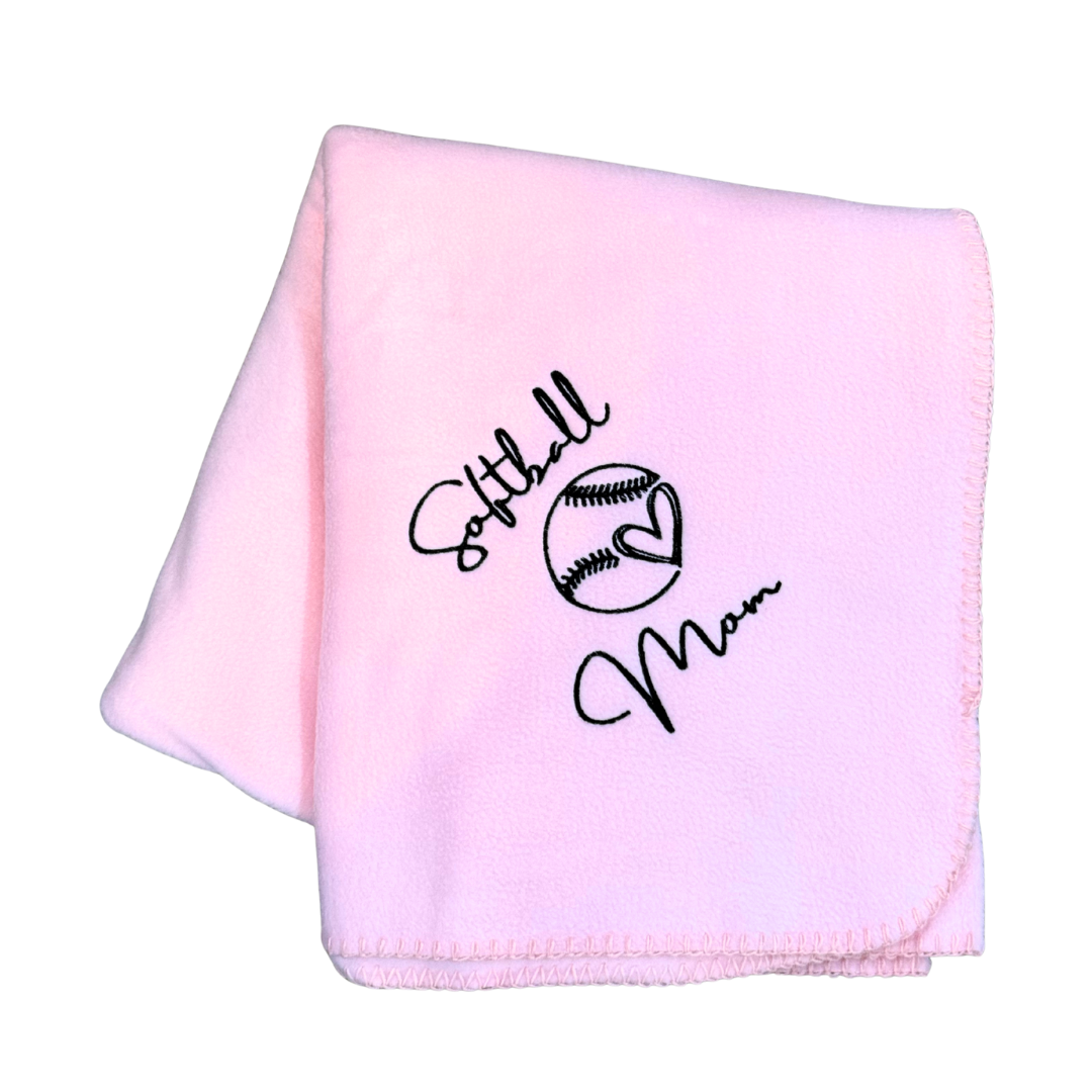 Pink blanket with 'Softball Mom' text and softball graphic in black thread stitching