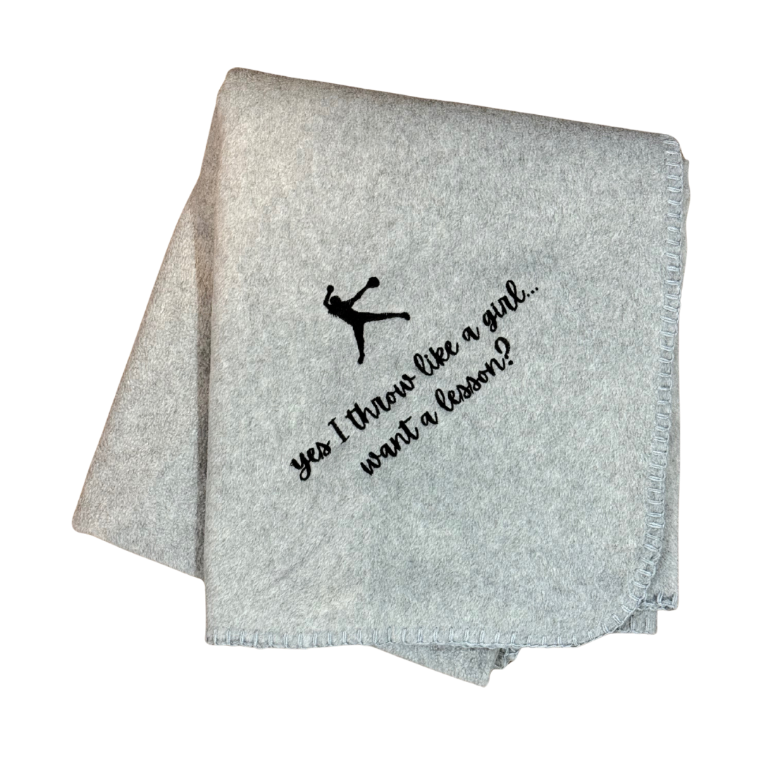 Gray blanket with black text and graphic