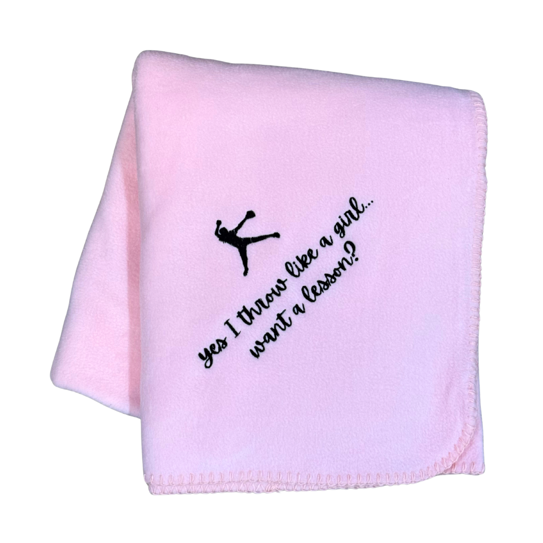 Pink blanket with black text and softball pitcher silhouette