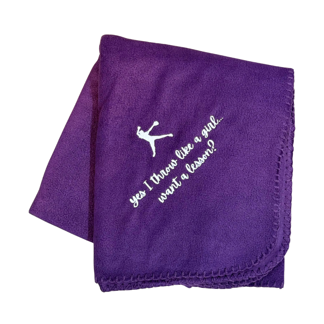 Purple blanket with white text and softball pitcher
