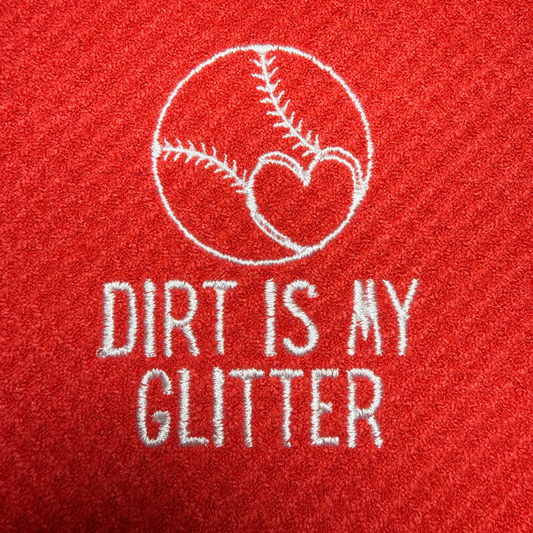 Red towel with white embroidered text 'Dirt is my Glitter' and a baseball heart design.