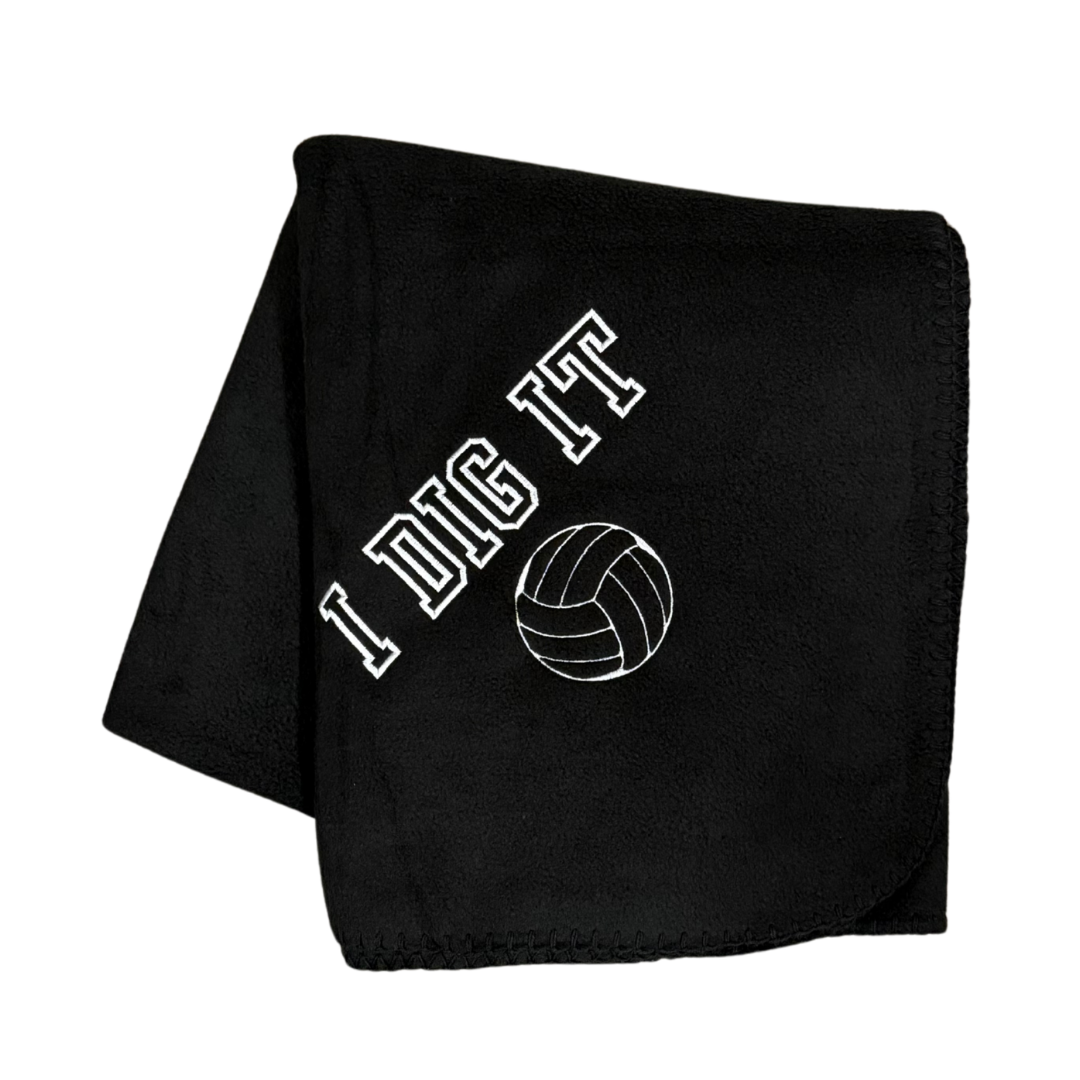black fleece blanket with I Dig It and a volleyball embroidered in white thread