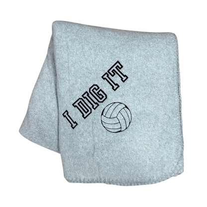 gray fleece blanket with I Dig It and a volleyball embroidered in black thread
