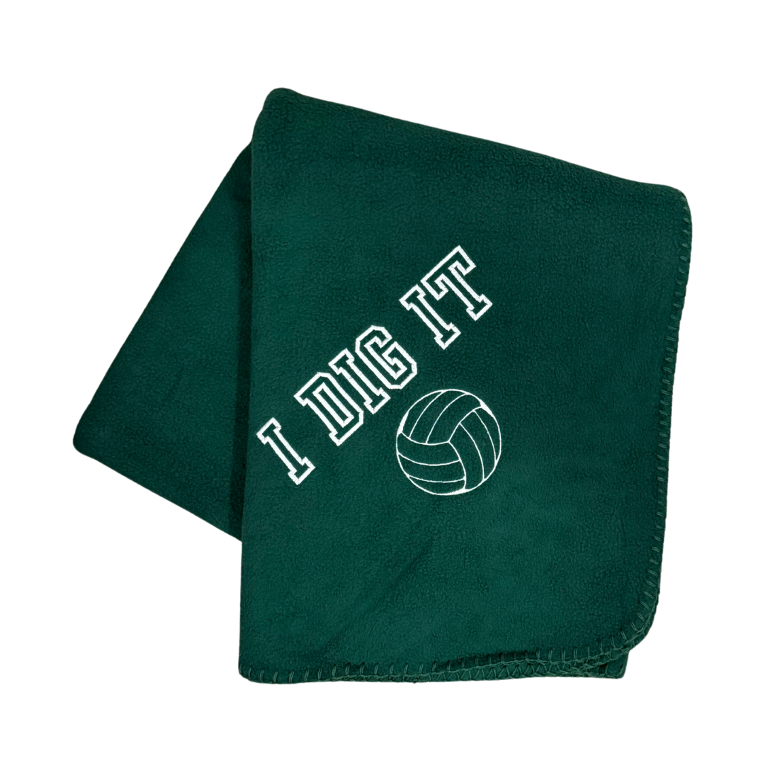 green fleece blanket with I Dig It and a volleyball embroidered in white thread
