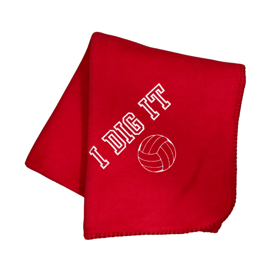 red fleece blanket with I Dig It and a volleyball embroidered in white thread