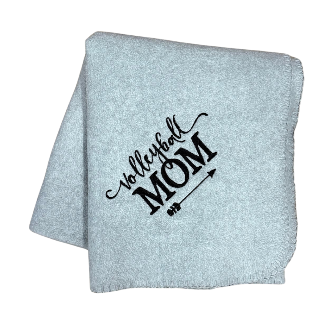 Light gray blanket with 'Volleyball Mom' text in a white stitching