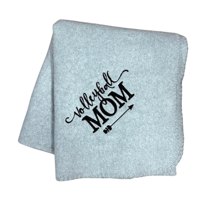 Light gray blanket with 'Volleyball Mom' text in a white stitching