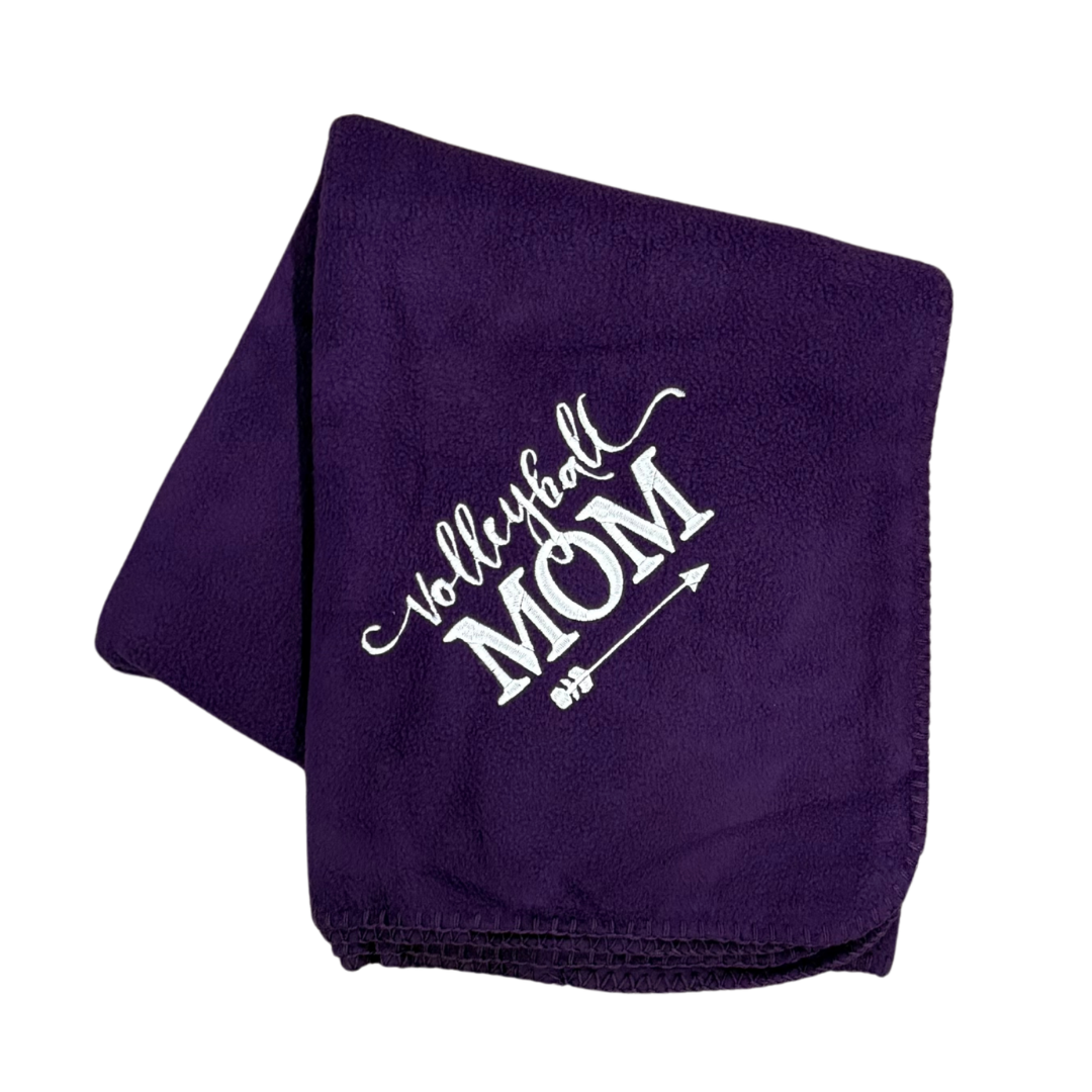 Purple blanket with 'Volleyball Mom' text in a white thread