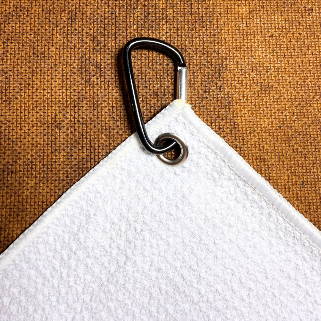 White towel with a metal carabiner clip 