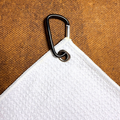 White towel with a metal carabiner clip 