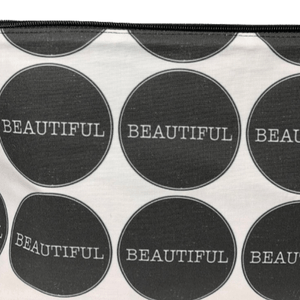 close up image of makeup bag with the word beautiful in the center of large black circles on white background