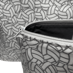 close up image of bag with gray lining, white zipper and overlapping white and gray volleyball fabricr