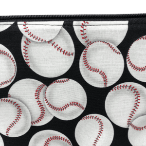 varying sized white baseballs with red stitiches on black background fabric