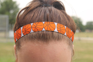 sporty girl accessories headband with orange basketballs on a girl with her hair pulled up