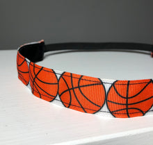 Load image into Gallery viewer, close up view of grosgrain ribbon on orange basketball headband
