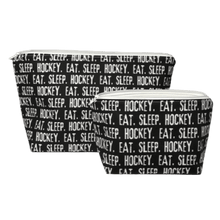 Load image into Gallery viewer, black and white hockey makeup bags with repeating phrase eat sleep hockey
