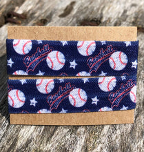 Load image into Gallery viewer, two navy blue softball sleeve clips on cardboard display
