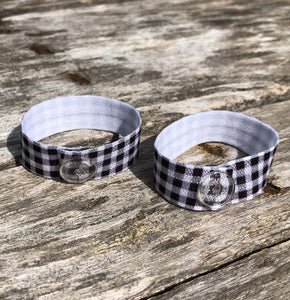 pair of black and white gingham sleeve clips with clear snaps