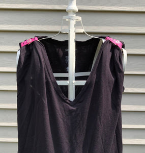 black tshirt with pink gymnast sleeve clips around sleeves making the shirt a tank top