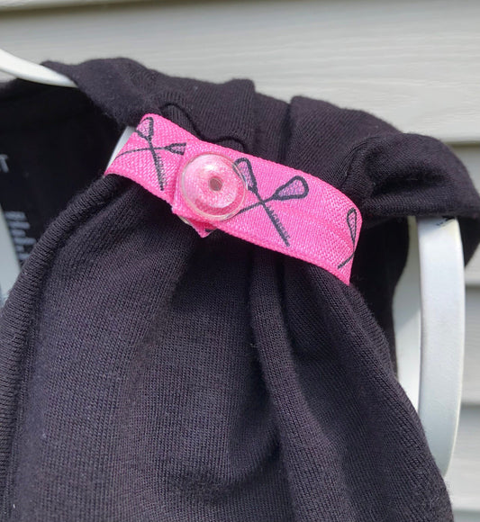 pink lacrosse sleeve clips on black shirt