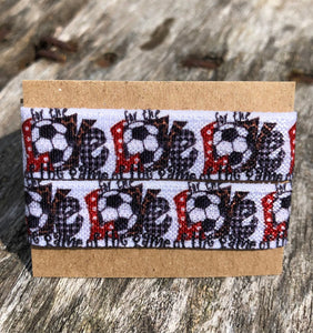 red white and blue soccer sleeve clips with "for the love of the game" pattern where a soccer ball is the O in soccer