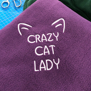 purple cat lady blanket with cat ears in white stitching