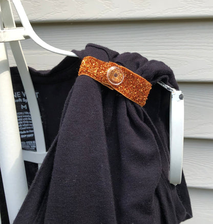 orange glittery sleeve clip on black tshirt