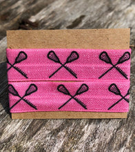 Load image into Gallery viewer, hot pink lacrosse sleeve clips with black lacrosse sticks in crossed formations
