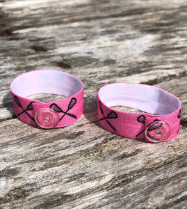 set of two pink lacrosse sleeve clips with clear snaps