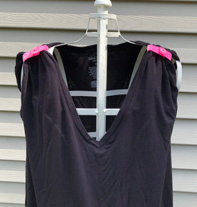 black tshirt with sleeves rolled up and held in place with pink glittery sleeve clips