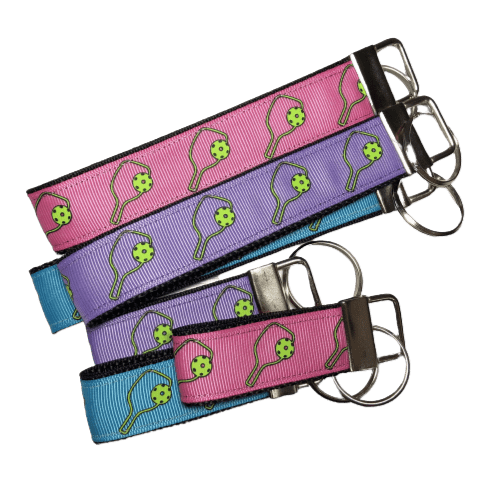 pickleball keychains in purrple, teal, and pink
