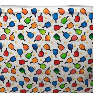 zippered bag with red, blue, green, and orange pickleball paddles and yellow pickleball fabric with white background