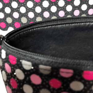 polka dot makeup bag with black zipper and vinyl lining