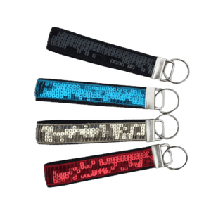 black, teal, gold, and red sequin keychains