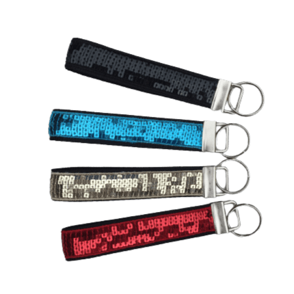 black, teal, gold, and red sequin keychains