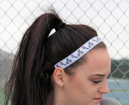 white tennis headband on model side view showing rackets